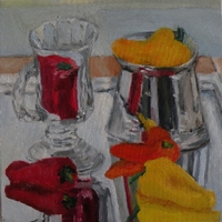 Several multicolored peppers and a glass mug on a mirror